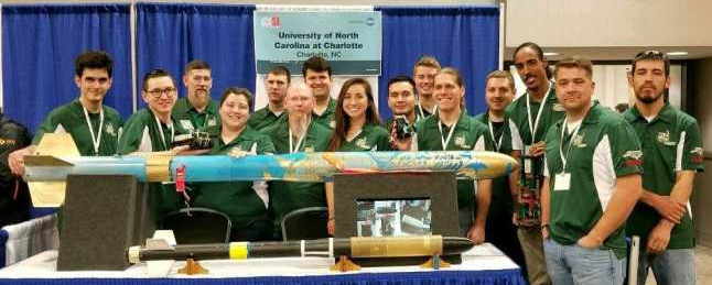 Adams stands with her teammates at the UNC Charlotte’s 49er Rocketry Club booth at the 2018 NASA Student Launch Initiative.