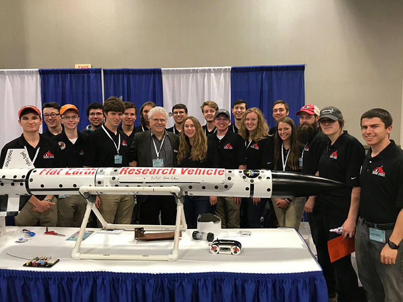 Homer Hickam, author of Rocket Boys and inspiration for the film October Sky, visits the NC State high-powered rocketry team's booth at the 2018 NASA competition. Lauer stands second from the right from Hickam.