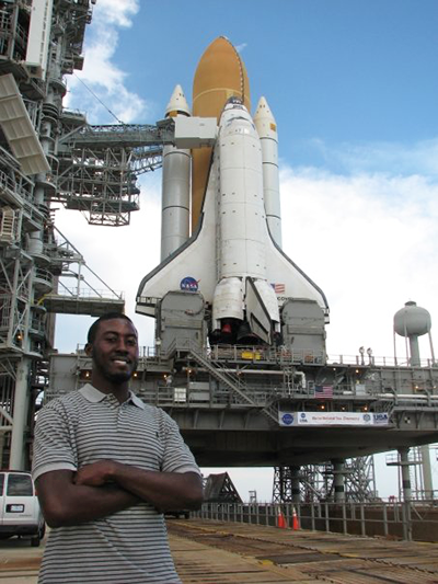 Keith Parker stops in front of the NASA space shuttle at NASA Kennedy Space Center in Florida.