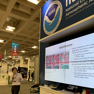 Theurer presents at the NOAA booth at the AGU Fall Meeting in 2019.