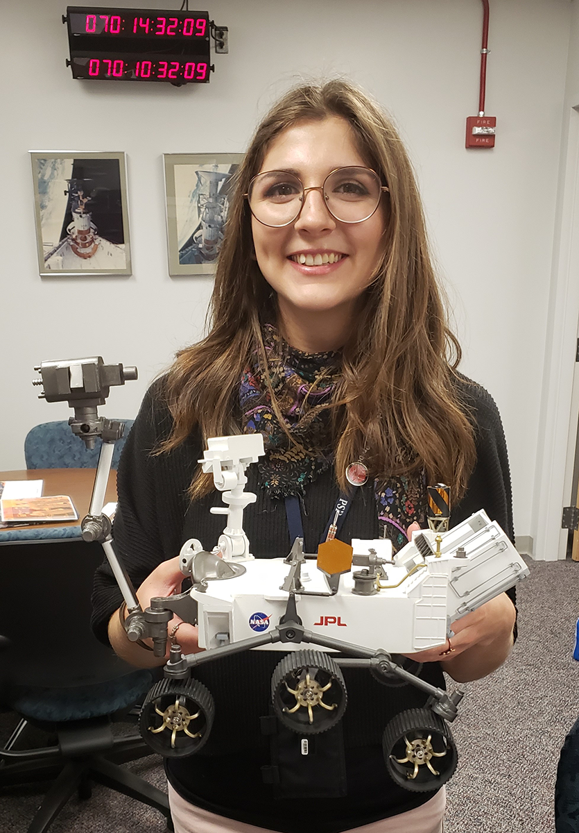Stephanie Smith holds a scale replica of the NASA Mars 2020 mission's Perseverance rover. Smith's company, United Launch Alliance (ULA), provided the rocket that launched the rover on its mission on July 30, 2020. Smith and her team ensured the rocket and payload were free of contaminants before launch.