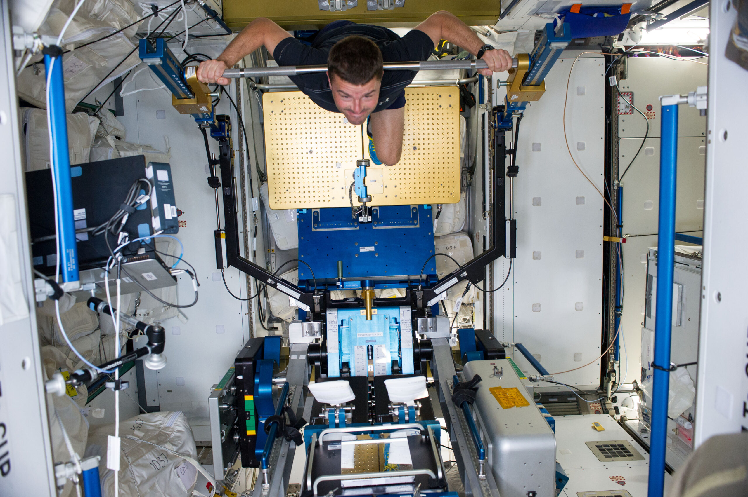 An astronaut uses the ARED machine on the International Space Station.