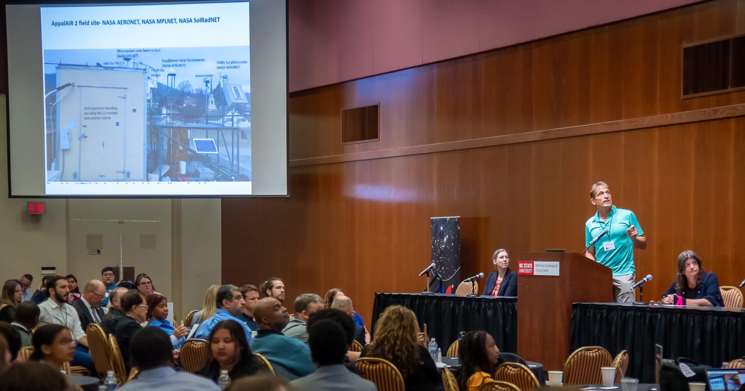 Researcher presenting research and speaking to audience