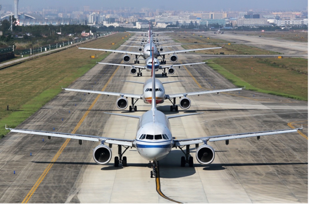 Commercial aircraft lined up on the runway waiting for takeoff.