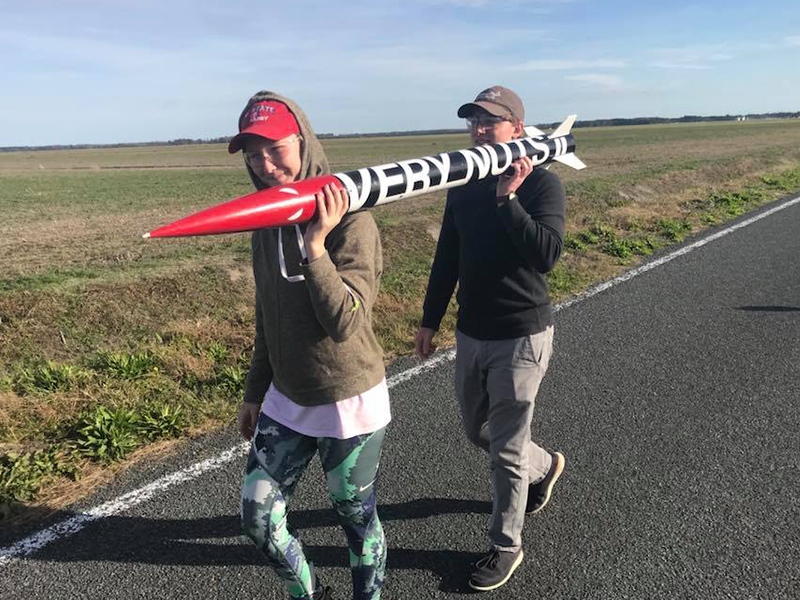 Lauer and a teammate carry their subscale rocket, "Very Nuts II," to the launch site at the 2018 NASA competition.